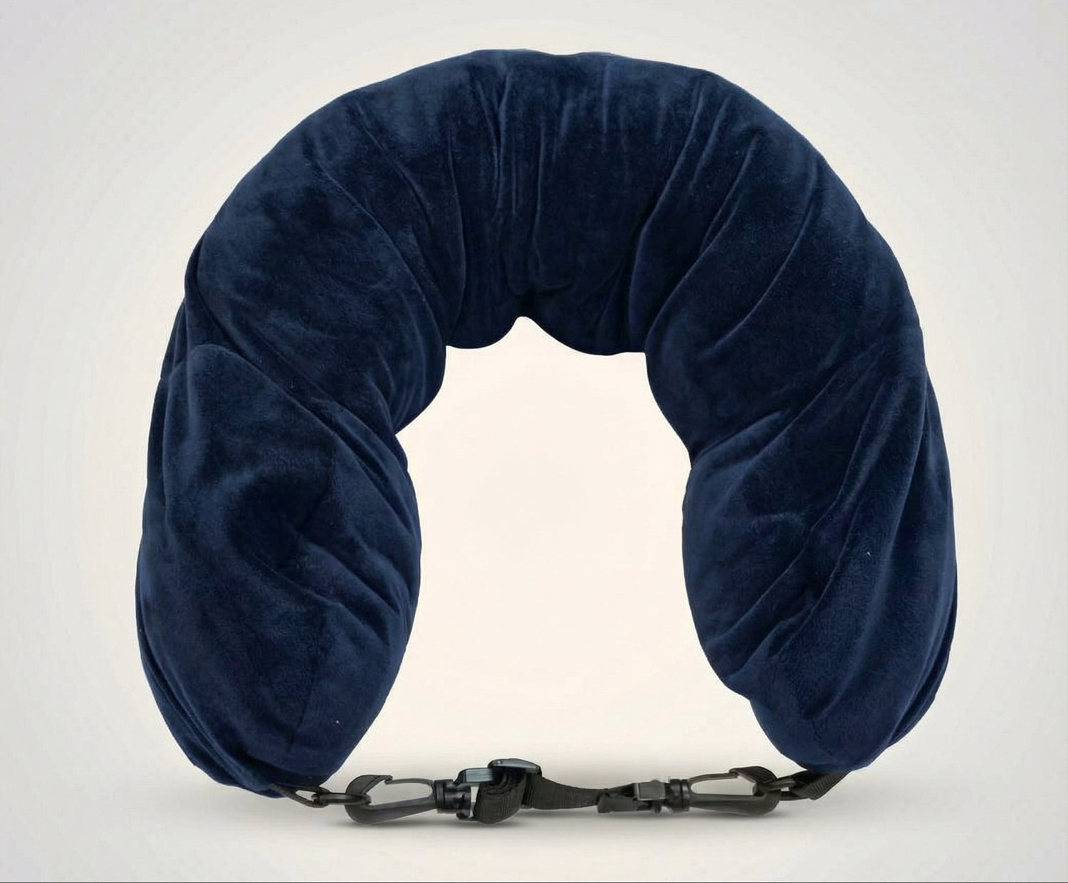Navy blue neck pillow with a strap on a white background
